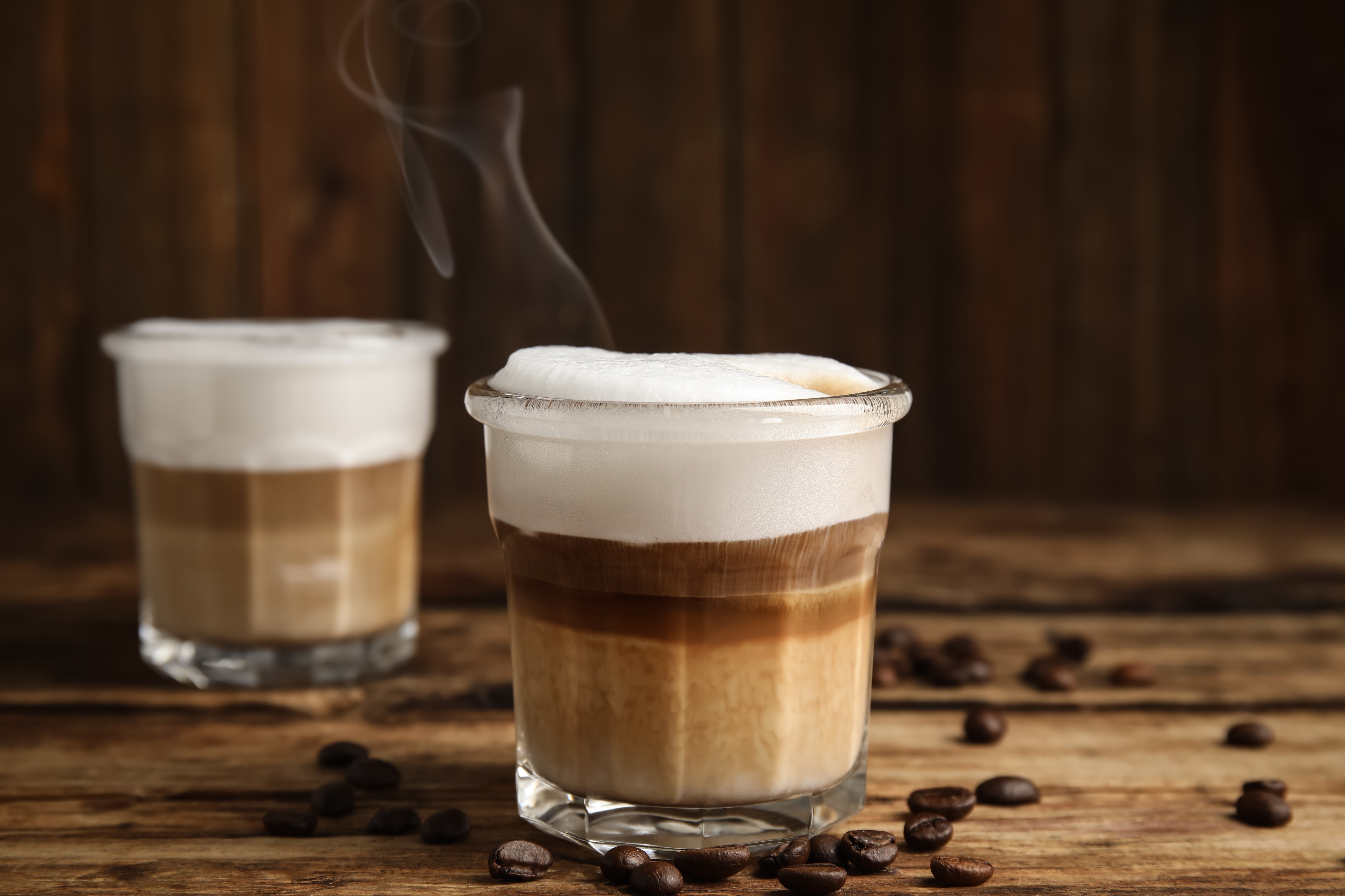 Close-up of the inside of a cup of coffee with a heart shaped froth